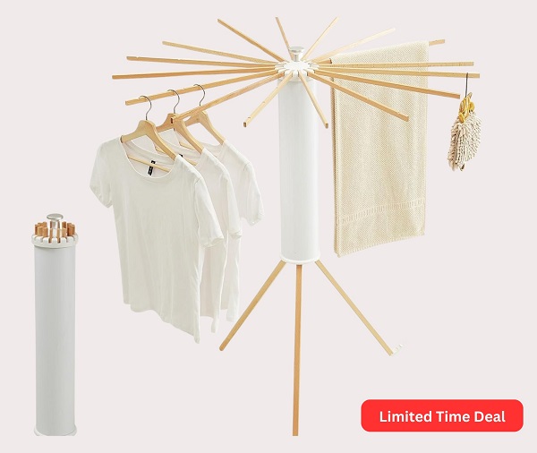 Foldable Tripod Clothes Drying Rack with clothes hanging on it indoors.