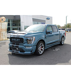 2023 Shelby Super Snake F-150 speeding down a road, highlighting its power and design.