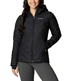 A woman wearing a Columbia Women's Heavenly Hooded Jacket, smiling and enjoying a winter day