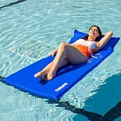 Adult relaxing on a self-inflating pool float in a pool.