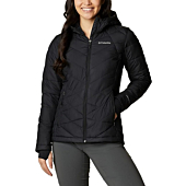 A woman wearing a Columbia Women's Heavenly Hooded Jacket, smiling and enjoying a winter day