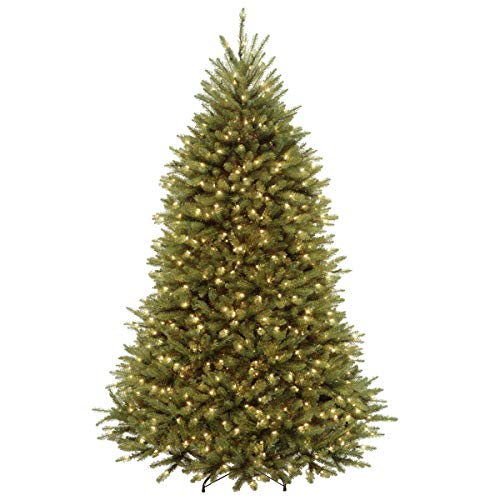 Pre-lit National Tree Company Dunhill Fir Christmas Tree with warm white and multi-colored LED lights illuminating a living room.