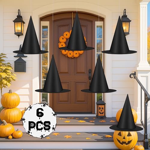 Black witch hats hanging for Halloween porch decor