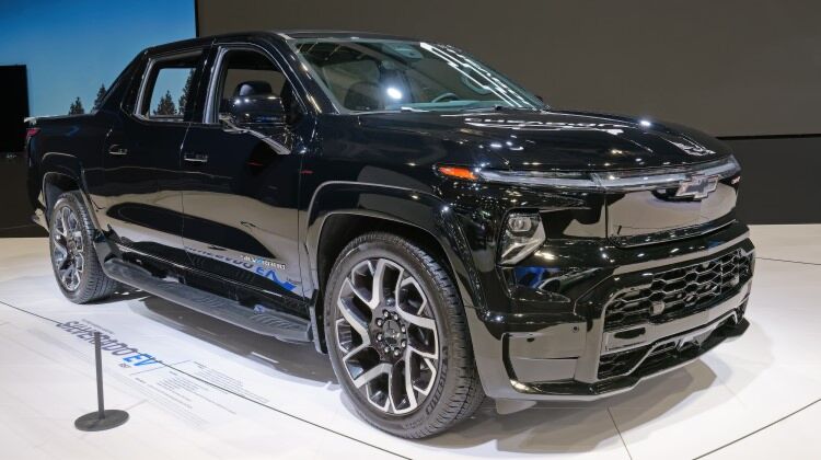 Black Chevrolet Silverado EV on display at a 2024 Auto Show