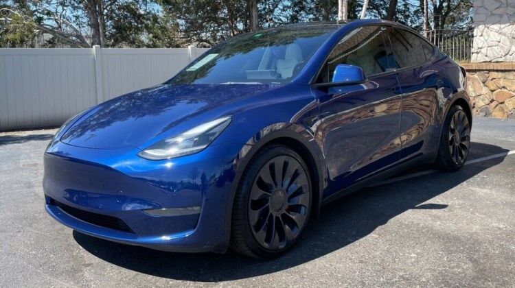 Electric Tesla Model Y parked on a residential street - eco-friendly and sustainable transportation option