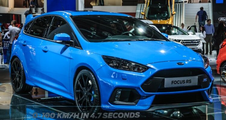 Blue 2016 Ford Focus RS hatchback with white text on the side reading 19 FOCUS RS 100 KM/H IN 4.7 SECONDS