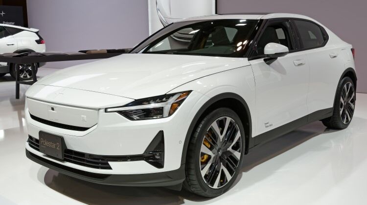 A White 2024 Polestar 2 electric car parked in a modern exhibition building